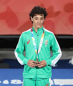 250px-2018-10-12_Wrestling_Boys_Greco-Roman_45kg_at_2018_Summer_Youth_Olympics_–_Medal_Ceremony_(Martin_Rulsch)_08